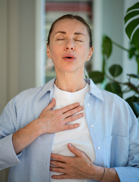 focused-on-breathing-middle-aged-woman-holding-han-2025-03-06-03-25-54-utc