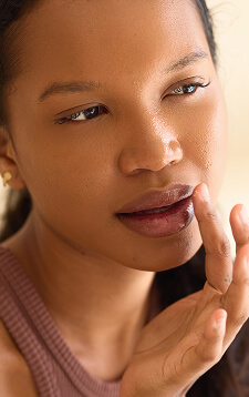 lip-care-routine-with-thoughtful-woman-applying-ba-2025-03-05-15-41-04-utc (1)